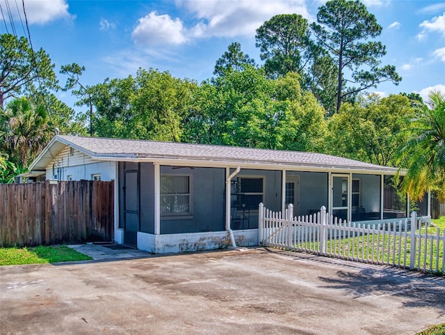 720 Meadow St, Sanford, FL 32773 - ranch-style home with a sunroom and roof with shingles