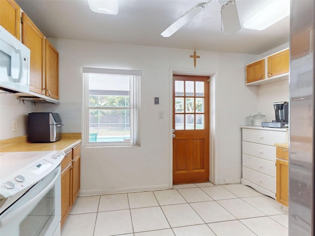720 Meadow St, Sanford, FL 32773 - kitchen with white appliances, light countertops, a ceiling fan, decorative backsplash, and light tile patterned flooring