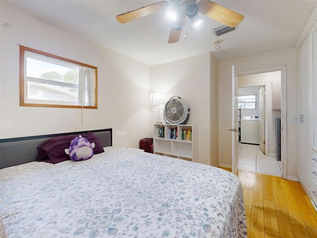720 Meadow St, Sanford, FL 32773 - bedroom featuring light wood-type flooring, washer / dryer, and ceiling fan