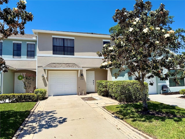 2120 Windsor Lake Cir, Sanford, FL 32773 - multi unit property featuring stucco siding, a garage, and concrete driveway
