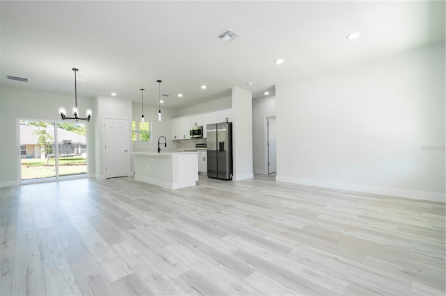 10333 N Halsey Way, Citrus Springs, FL 34434 - unfurnished living room featuring a chandelier, recessed lighting, baseboards, and light wood-type flooring