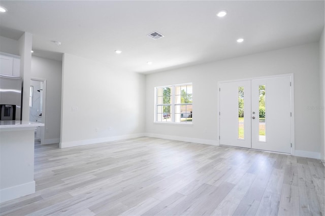 10333 N Halsey Way, Citrus Springs, FL 34434 - unfurnished living room featuring light wood finished floors, recessed lighting, baseboards, and french doors