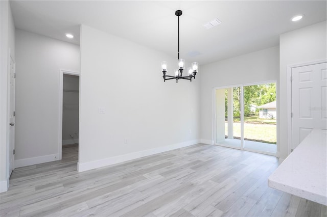 10333 N Halsey Way, Citrus Springs, FL 34434 - unfurnished dining area with a chandelier, light wood-style flooring, baseboards, and recessed lighting