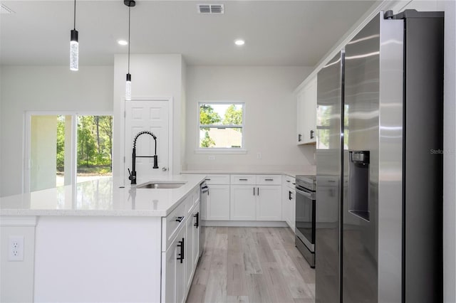 10333 N Halsey Way, Citrus Springs, FL 34434 - kitchen with stainless steel appliances, a sink, light wood-type flooring, white cabinets, and recessed lighting