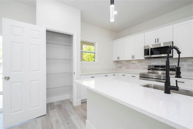 10333 N Halsey Way, Citrus Springs, FL 34434 - kitchen with appliances with stainless steel finishes, white cabinetry, decorative backsplash, and light stone counters