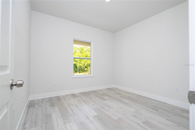 10333 N Halsey Way, Citrus Springs, FL 34434 - unfurnished room with light wood-style floors and baseboards