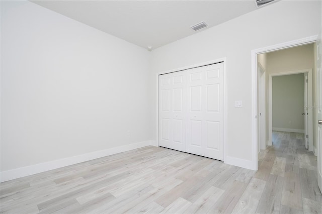 10333 N Halsey Way, Citrus Springs, FL 34434 - unfurnished bedroom with light wood-style floors, a closet, and baseboards