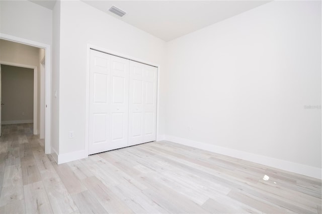 10333 N Halsey Way, Citrus Springs, FL 34434 - unfurnished bedroom featuring light wood-style floors, a closet, and baseboards