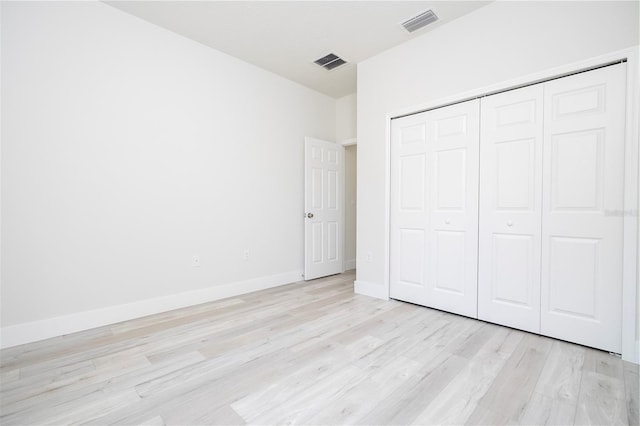 10333 N Halsey Way, Citrus Springs, FL 34434 - unfurnished bedroom featuring light wood-type flooring, a closet, and baseboards
