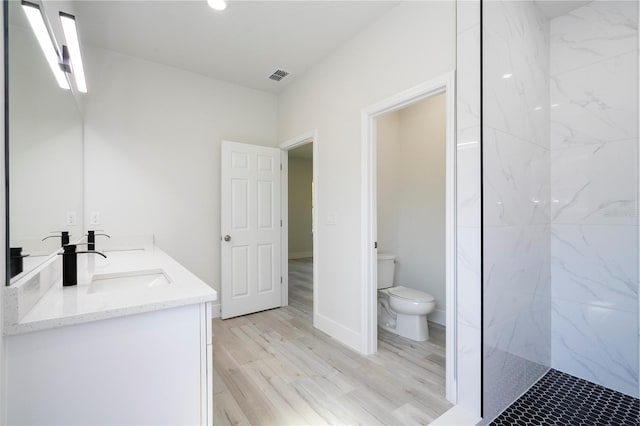 10333 N Halsey Way, Citrus Springs, FL 34434 - full bathroom featuring toilet, double vanity, wood finished floors, and a marble finish shower