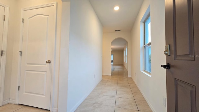 3202 Timber Hawk Cir, Ocoee, FL 34761 - corridor with arched walkways, light tile patterned floors, and baseboards