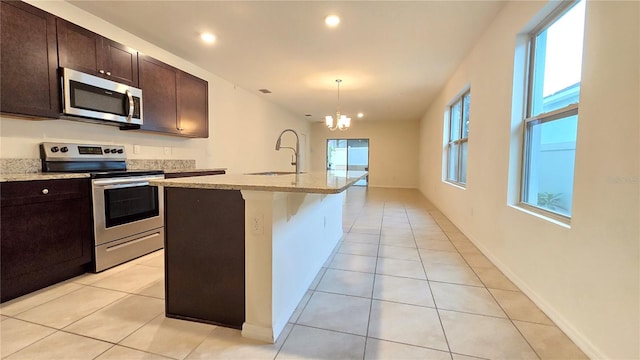 3202 Timber Hawk Cir, Ocoee, FL 34761 - kitchen featuring stainless steel appliances, a sink, a chandelier, light tile patterned floors, and recessed lighting