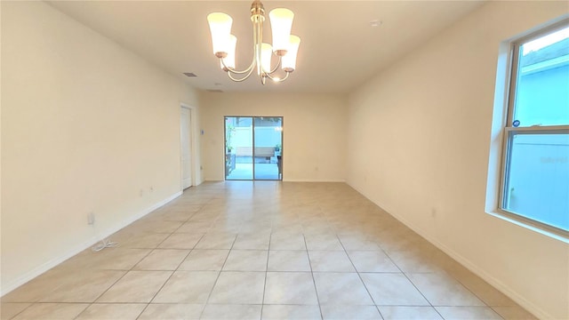 3202 Timber Hawk Cir, Ocoee, FL 34761 - spare room featuring healthy amount of natural light, a chandelier, light tile patterned floors, and baseboards