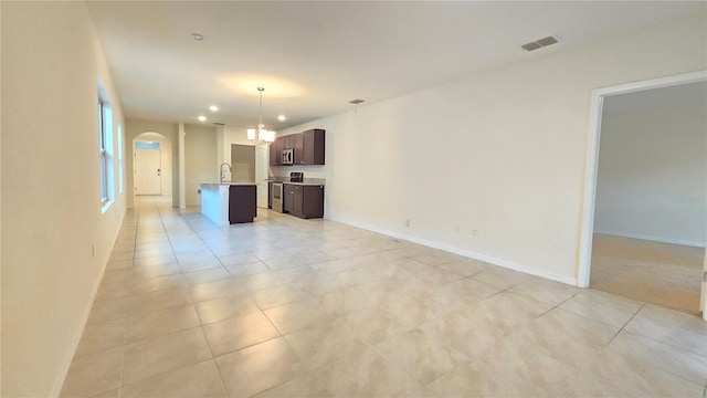 3202 Timber Hawk Cir, Ocoee, FL 34761 - unfurnished living room featuring arched walkways, light tile patterned floors, a chandelier, baseboards, and recessed lighting