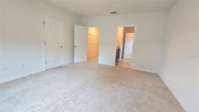 3202 Timber Hawk Cir, Ocoee, FL 34761 - unfurnished bedroom with light carpet, a walk in closet, baseboards, and a closet