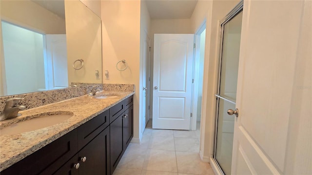 3202 Timber Hawk Cir, Ocoee, FL 34761 - full bathroom featuring double vanity, tile patterned flooring, an enclosed shower, and baseboards