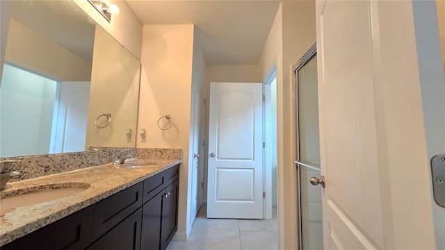 3202 Timber Hawk Cir, Ocoee, FL 34761 - bathroom with double vanity, tile patterned floors, and a shower with door