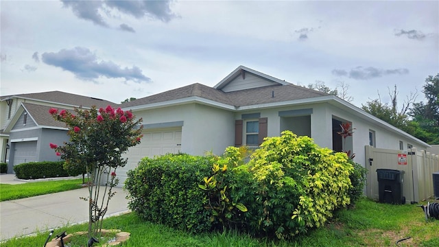3202 Timber Hawk Cir, Ocoee, FL 34761 - single story home featuring an attached garage, stucco siding, roof with shingles, and driveway