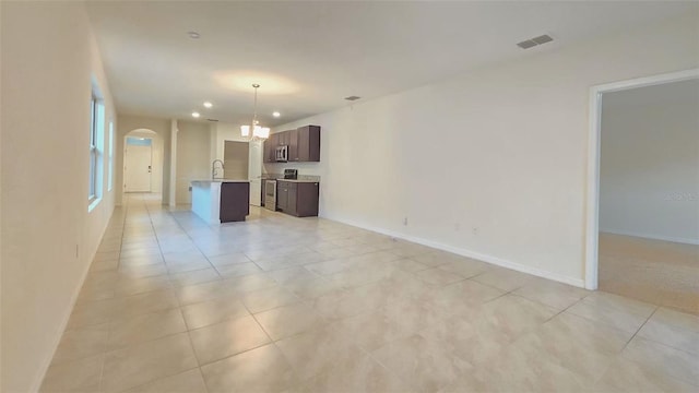 3202 Timber Hawk Cir, Ocoee, FL 34761 - unfurnished living room featuring arched walkways, a chandelier, light tile patterned floors, and recessed lighting