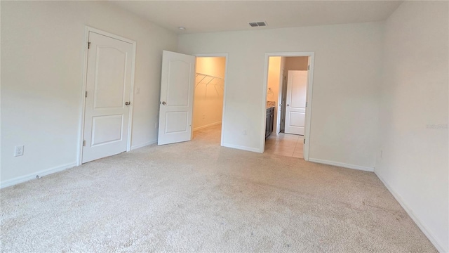 3202 Timber Hawk Cir, Ocoee, FL 34761 - unfurnished bedroom featuring light carpet, a spacious closet, a closet, and ensuite bathroom