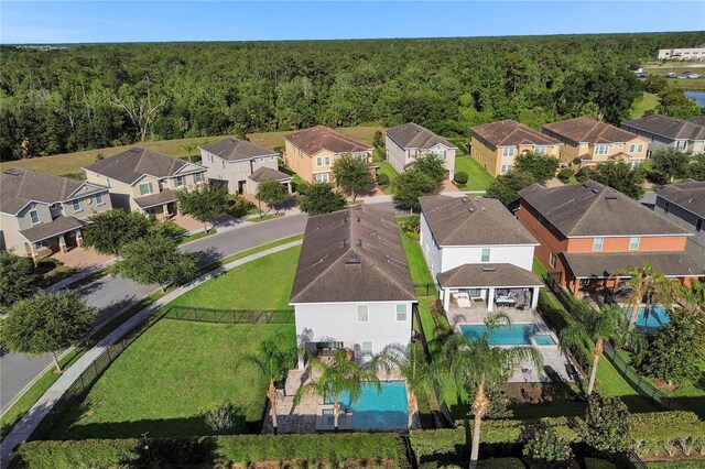 7524 Marker Ave, Kissimmee, FL 34747 - aerial perspective of suburban area with a pool area and a heavily wooded area