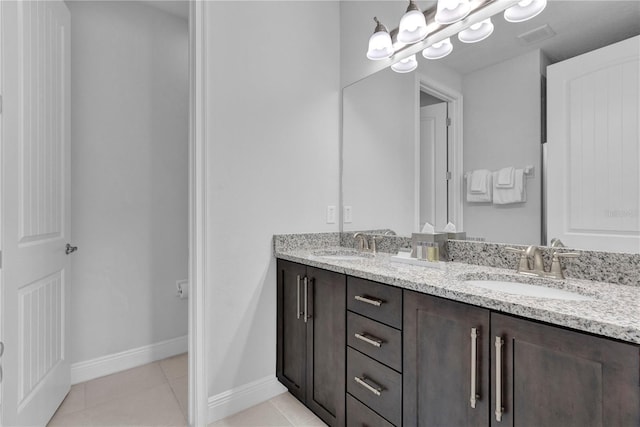 7524 Marker Ave, Kissimmee, FL 34747 - bathroom with double vanity, tile patterned flooring, baseboards, and a chandelier