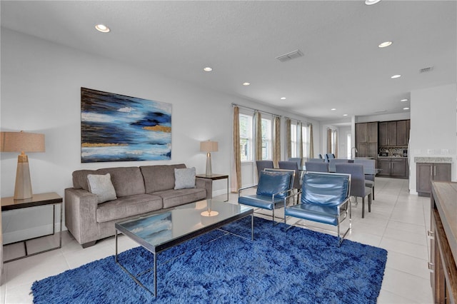 7524 Marker Ave, Kissimmee, FL 34747 - living area with recessed lighting and light tile patterned flooring