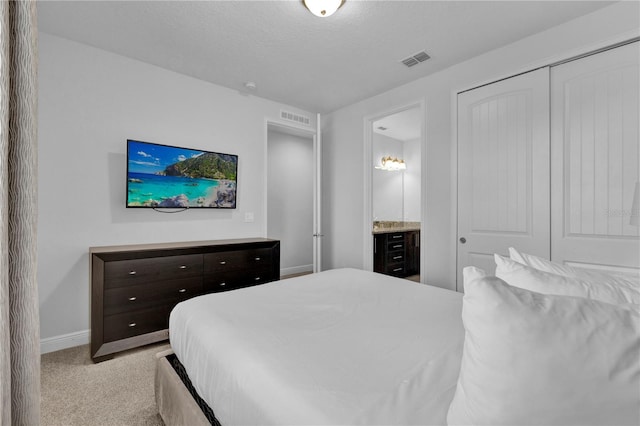7524 Marker Ave, Kissimmee, FL 34747 - bedroom featuring baseboards, light colored carpet, a closet, and ensuite bath