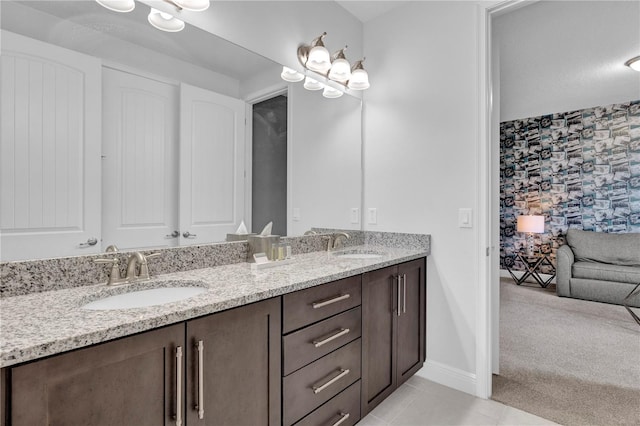 7524 Marker Ave, Kissimmee, FL 34747 - full bathroom featuring double vanity, tile patterned flooring, wallpapered walls, and baseboards