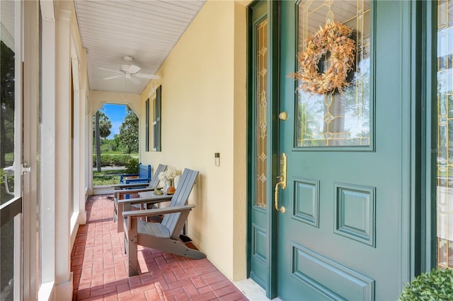 217 Lake Cassidy Dr, Kissimmee, FL 34759 - property entrance with covered porch, stucco siding, and a ceiling fan