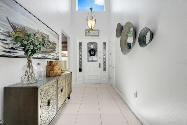 217 Lake Cassidy Dr, Kissimmee, FL 34759 - foyer entrance with light tile patterned flooring, a high ceiling, and baseboards