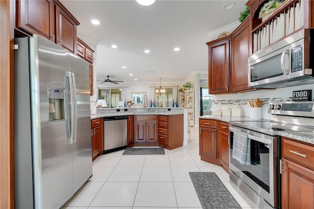 217 Lake Cassidy Dr, Kissimmee, FL 34759 - kitchen featuring stainless steel appliances, a peninsula, crown molding, a ceiling fan, and light stone counters