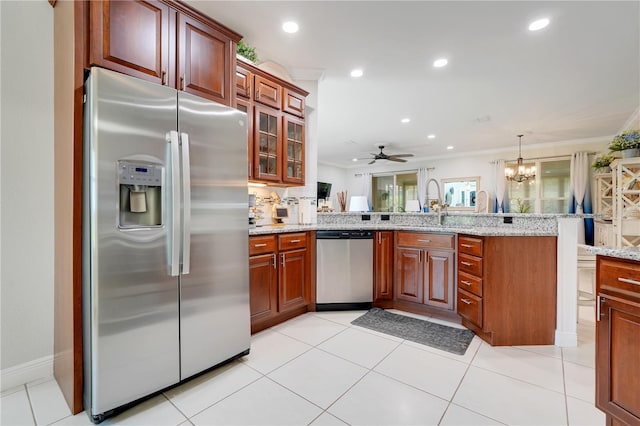 217 Lake Cassidy Dr, Kissimmee, FL 34759 - kitchen featuring appliances with stainless steel finishes, ornamental molding, a peninsula, light stone countertops, and recessed lighting