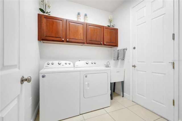 217 Lake Cassidy Dr, Kissimmee, FL 34759 - washroom featuring washing machine and dryer, cabinet space, light tile patterned floors, and baseboards