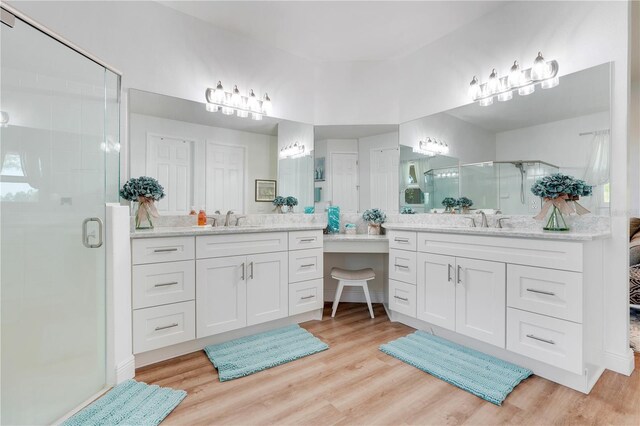 217 Lake Cassidy Dr, Kissimmee, FL 34759 - full bath with a stall shower, two vanities, and wood finished floors