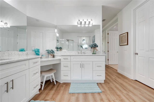 217 Lake Cassidy Dr, Kissimmee, FL 34759 - full bathroom with a stall shower, wood finished floors, and two vanities