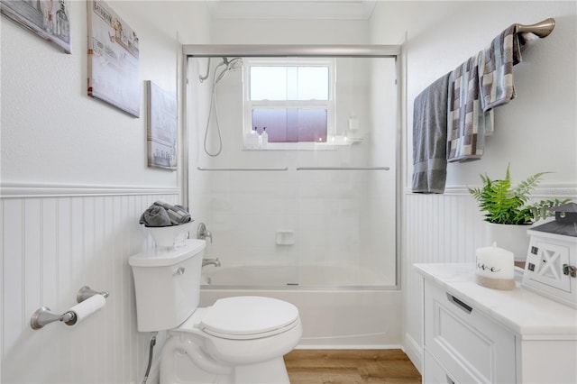 217 Lake Cassidy Dr, Kissimmee, FL 34759 - full bathroom featuring toilet, enclosed tub / shower combo, wood finished floors, wainscoting, and ornamental molding
