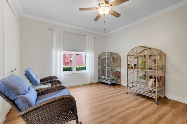 217 Lake Cassidy Dr, Kissimmee, FL 34759 - living area with light wood-type flooring, baseboards, ceiling fan, and ornamental molding
