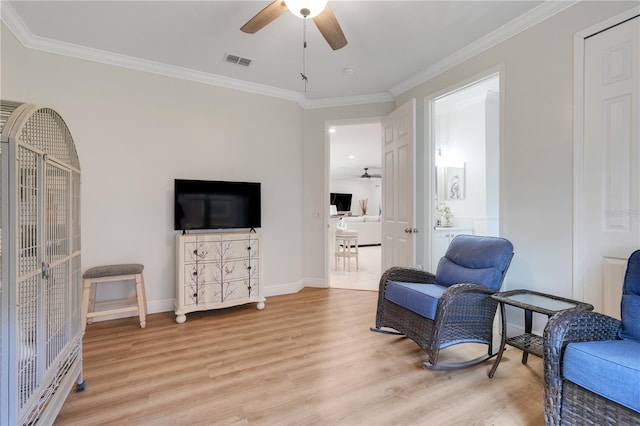 217 Lake Cassidy Dr, Kissimmee, FL 34759 - living area featuring a ceiling fan, light wood-type flooring, baseboards, and ornamental molding