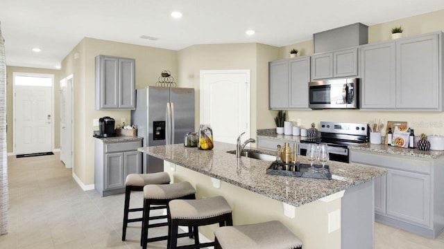 4932 Kaia Ave, Winter Haven, FL 33884 - kitchen featuring appliances with stainless steel finishes, a sink, gray cabinetry, light stone counters, and recessed lighting