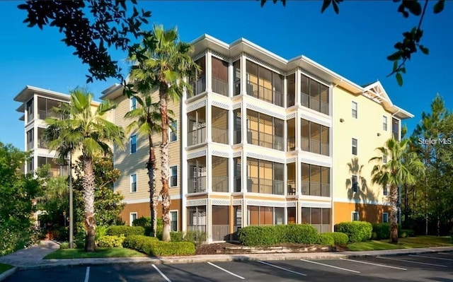 9051 Treasure Trove Ln Unit 505, Kissimmee, FL 34747 - view of apartment building / complex featuring uncovered parking
