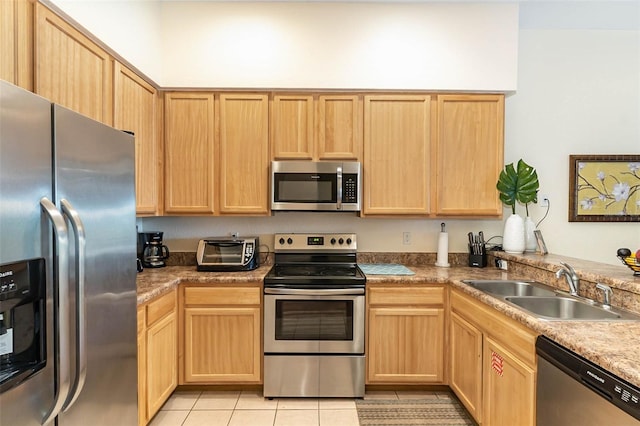 9051 Treasure Trove Ln Unit 505, Kissimmee, FL 34747 - kitchen featuring stainless steel appliances, a sink, light brown cabinetry, and light tile patterned floors