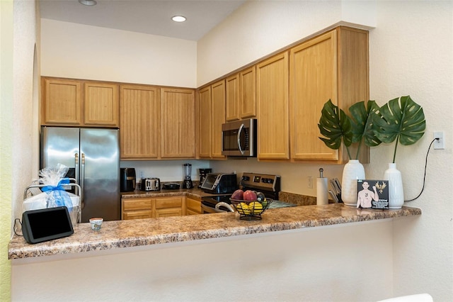 9051 Treasure Trove Ln Unit 505, Kissimmee, FL 34747 - kitchen featuring appliances with stainless steel finishes, a peninsula, and recessed lighting