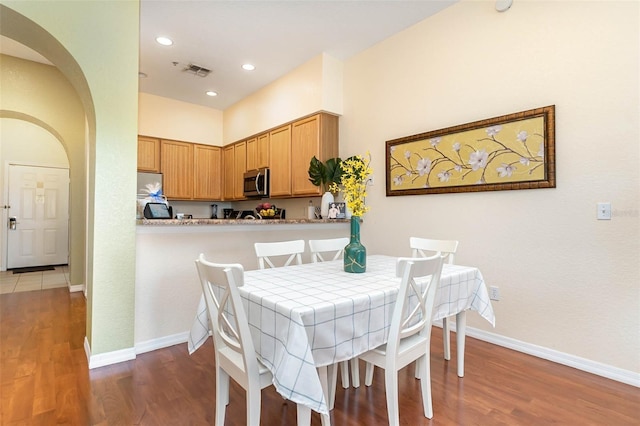 9051 Treasure Trove Ln Unit 505, Kissimmee, FL 34747 - dining room with arched walkways, wood finished floors, recessed lighting, and baseboards
