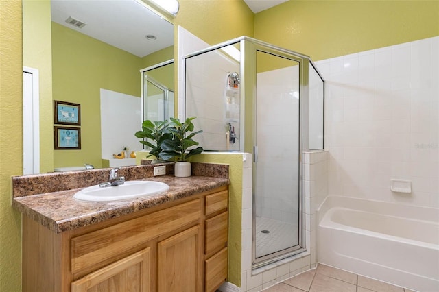 9051 Treasure Trove Ln Unit 505, Kissimmee, FL 34747 - bathroom featuring a stall shower, vanity, a bath, tile patterned flooring, and a textured wall