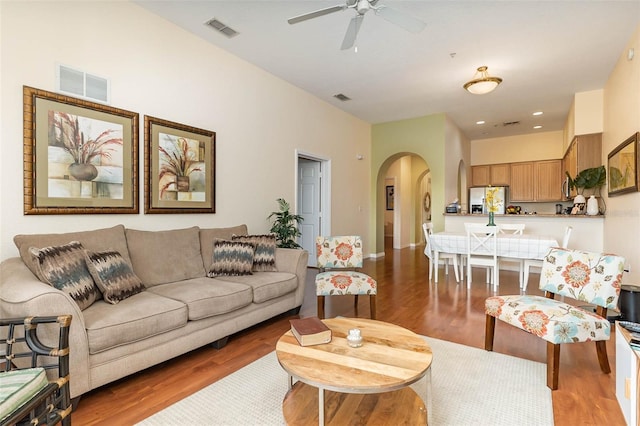9051 Treasure Trove Ln Unit 505, Kissimmee, FL 34747 - living room with arched walkways, wood finished floors, ceiling fan, baseboards, and recessed lighting