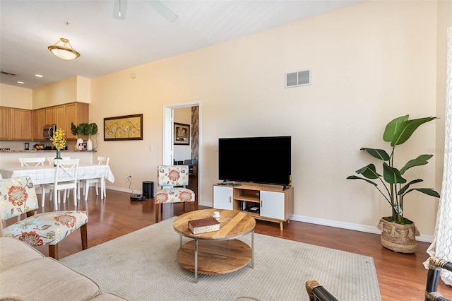 9051 Treasure Trove Ln Unit 505, Kissimmee, FL 34747 - living room with wood finished floors, baseboards, and a ceiling fan
