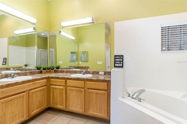 9051 Treasure Trove Ln Unit 505, Kissimmee, FL 34747 - full bathroom with double vanity, a garden tub, a shower with shower door, and tile patterned flooring