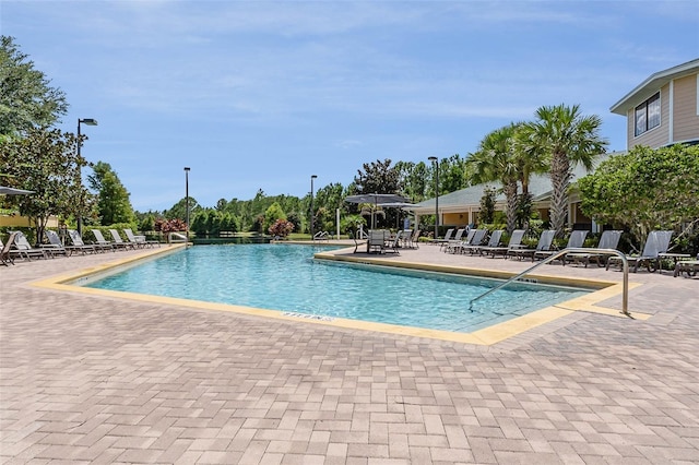 9051 Treasure Trove Ln Unit 505, Kissimmee, FL 34747 - community pool featuring a patio area