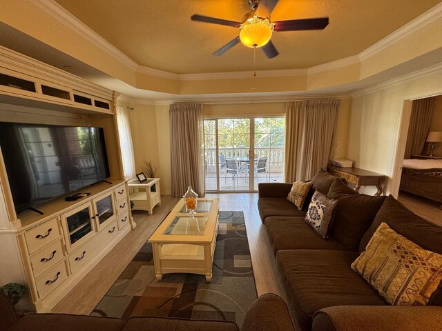 7651 Whisper Way Unit 201, Kissimmee, FL 34747 - living room with a tray ceiling, crown molding, ceiling fan, and wood finished floors
